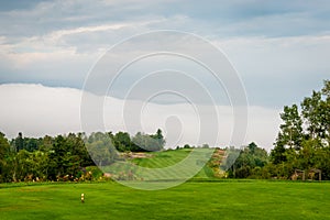 Foggy day by the St-Laurent river, golf fiel