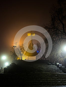 Foggy evening on Cetatuia Hill from Cluj-Napoca city in Romania