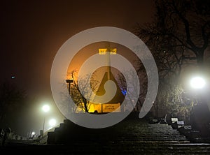 Foggy evening on Cetatuia Hill from Cluj-Napoca city in Romania