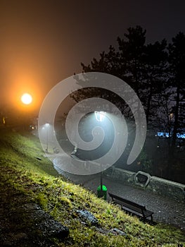 Foggy evening on Cetatuia Hill from Cluj-Napoca city in Romania