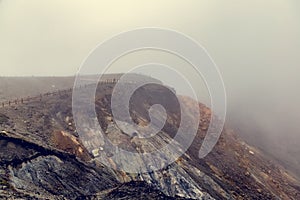 Foggy landscape of the edge of Aso volcano crater