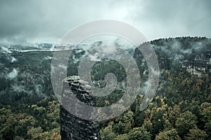 Foggy landscape. Misty foggy morning with sunrise in a valley of Bohemian Switzerland park. Detail of forest, landscape of Czech