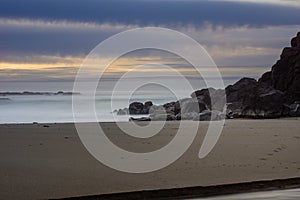 Foggy mist over the surf on a rocky coast