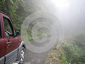 Foggy misty mountain road in India