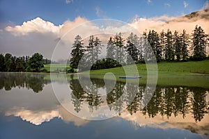 Foggy Morning on lake, with beautiful clouds and reflection