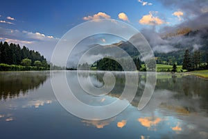 Foggy Morning on lake landscape, with beautiful clouds and reflection