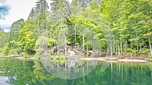 Spring mountain lake landscape and reflection. Alpine nature with morning haze, relax scenic view, natural view