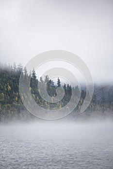 Foggy morning. Lower Multinskoe Lake. Mountain Altai autumn land