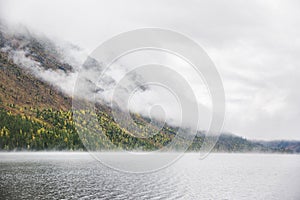 Foggy morning. Lower Multinskoe Lake. Mountain Altai autumn land