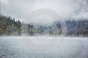 Foggy morning. Lower Multinskoe Lake. Mountain Altai autumn land