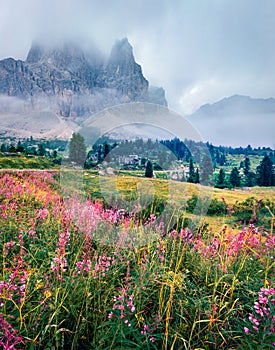 Foggy morning view of Pista Lagazuoi mountain peak from Falzarego pass. Picturesque summer scene of Dolomiti Alps