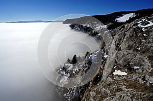 Foggy mountain landscape in Austria. Beautiful mountain valley filled with early morning mist. Dramatic foggy mountain range rise