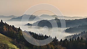 Foggy mountain landscape at dawn. Autumn scenery. Slovenia