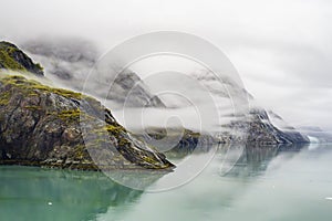 Foggy mountain landscape and shoreline from Alaska in Autumn.