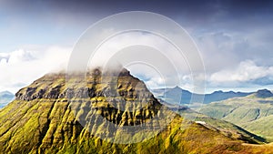 Foggy mountain peaks and clouds covering sea and mountains