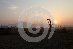 Foggy mountain valley at sunrise in the village in Nasik, Maharashtra, India