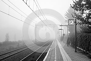 Foggy morning at small Dutch trainstation photo