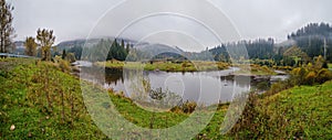 Foggy and overcast autumn day in Carpathian Mountains. Rika river bend, Transcarpathia, Ukraine