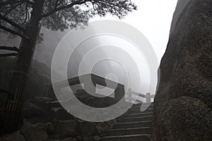 Foggy Rainny day. Stone Steep Steps . Treking walking hking Huangshan Mountain. Anhui, China. April 2009