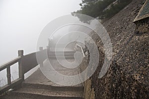 Foggy Rainny day. Stone Steep Steps . Treking walking hking Huangshan Mountain. Anhui, China. April 2009