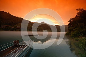 Foggy river in sunset