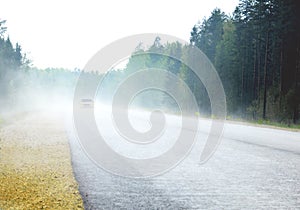THE FOGGY ROAD WITH CAR