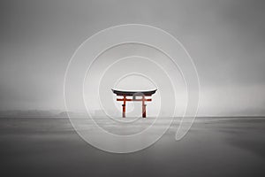 Foggy shot of the floating torii of Miyajima, Japan during rain