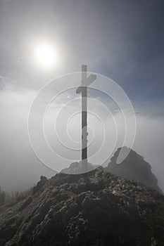 Foggy summit cross at Taubenstein mountain, Bavaria
