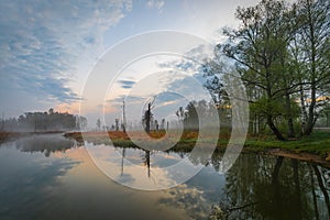 Foggy sunrise over the lake in Mazury region, Poland in impressionism style