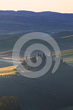 Foggy sunrise over the rural house with vineyards