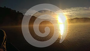 Foggy sunrise reflection