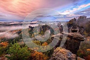 Foggy sunrise in the Saxon Switzerland, Germany, view from the Bastei lookout point. photo