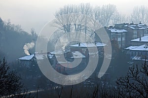 Foggy townscape and smoking chimneys