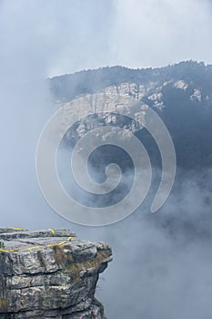 Foggy valley with cliff rock