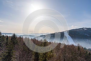 Foggy view of Beskid Sadecki mountain range on a sunny day