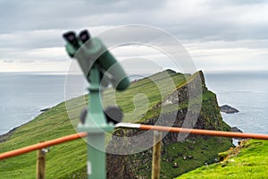 Foggy view of old lighthouse on the Mykines island