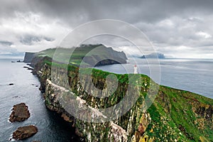 Foggy view of old lighthouse on the Mykines island