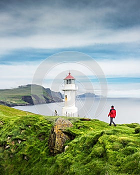 Foggy view of old lighthouse on the Mykines island