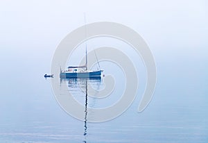 Foggy water sailboat