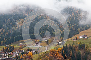 Foggy weather in Ortisei St. Ulrich in beautiful autumn colors, Trentino-Alto Adige, Bolzano province in South Tyrol