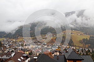 Foggy weather in Ortisei St. Ulrich in beautiful autumn colors, Trentino-Alto Adige, Bolzano province in South Tyrol