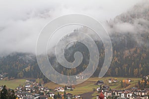 Foggy weather in Ortisei St. Ulrich in beautiful autumn colors, Trentino-Alto Adige, Bolzano province in South Tyrol