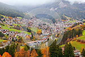 Foggy weather in Ortisei St. Ulrich in beautiful autumn colors, Trentino-Alto Adige, Bolzano province in South Tyrol