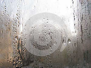 Foggy window. Closeup shot of a steamy window with water drops