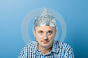 Foil hat on man. Protects from reading think