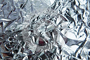 Foil texture background with shiny crumpled surface for textural background