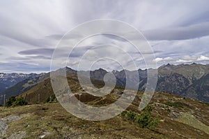 Fokus on the heather in front. Panoramic view on the moserkopf, Austria to the surrounding mountain peaks. Autumn mood