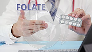 Folate blister pack with tablets in doctor`s hand