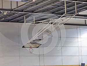 Foldable basketball hoop in the high school gym. Safety nets