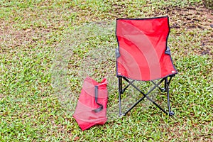 Foldable camping chair with the green lawn background. photo